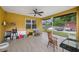 Covered patio with a ceiling fan offers a comfortable outdoor living space with ample seating and natural light at 534 Berkley Ave, Tarpon Springs, FL 34689