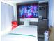 Comfortable bedroom featuring stylish Murphy bed, mini-fridge, closet, and modern decor, perfect for relaxation at 5434 Fairfield S Ave # 1, Gulfport, FL 33707