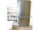 Spacious kitchen with stainless steel refrigerator and convenient pull-out pantry shelves for organized storage at 5434 Fairfield S Ave # 1, Gulfport, FL 33707