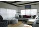 Cozy living room with natural light, stylish sectional sofa, and hardwood floors at 5434 Fairfield S Ave # 1, Gulfport, FL 33707