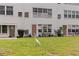 A great egret wanders on the lawn near condo entrances, evoking a coastal vibe at 5603 80Th N St # 107, St Petersburg, FL 33709