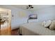 Cozy bedroom with wood floors features a dresser and queen bed at 5603 80Th N St # 107, St Petersburg, FL 33709
