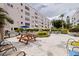 A charming courtyard with picnic tables and seating for outdoor enjoyment at 5603 80Th N St # 107, St Petersburg, FL 33709