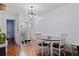 Dining room with elegant light fixture, a mirror, and wood-look floors at 5603 80Th N St # 107, St Petersburg, FL 33709