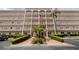 Well-maintained building with manicured landscaping, and an American flag prominently displayed at 5603 80Th N St # 107, St Petersburg, FL 33709