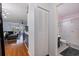 This view of the house shows the wood floors, a coat closet, the bathroom, and the living room at 5603 80Th N St # 107, St Petersburg, FL 33709