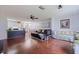 Open-concept living area with hardwood floors connects to a dining space and kitchen, ideal for modern living at 5603 80Th N St # 107, St Petersburg, FL 33709