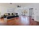 Bright living room boasts hardwood floors, ceiling fan, and modern furnishings, creating a welcoming and stylish atmosphere at 5603 80Th N St # 107, St Petersburg, FL 33709