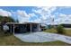 Single-story home with a carport, neatly maintained landscaping, and an American flag displayed at 5647 Arrowhead Dr, Zephyrhills, FL 33542