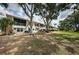 Lush backyard featuring mature trees and well-maintained lawn area perfect for outdoor enjoyment at 5694 40Th N Ter # 423, Kenneth City, FL 33709