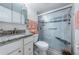 Bathroom featuring a glass enclosed shower, grey tile, granite countertops and updated fixtures at 5694 40Th N Ter # 423, Kenneth City, FL 33709
