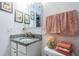 Bathroom vanity with granite counters, a decoratively framed mirror, and decorative peach colored towels at 5694 40Th N Ter # 423, Kenneth City, FL 33709