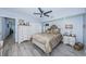 Comfortable bedroom featuring a ceiling fan, dresser, nightstands and light colored walls at 5694 40Th N Ter # 423, Kenneth City, FL 33709