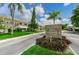 Stone signage at the entrance to Clearview Oaks Condominium set against a backdrop of lush landscaping and residences at 5694 40Th N Ter # 423, Kenneth City, FL 33709