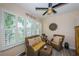 Cozy Florida room with wood-look flooring, white shuttered windows, and wicker furniture at 5694 40Th N Ter # 423, Kenneth City, FL 33709