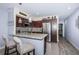 Modern kitchen featuring a breakfast bar, granite countertops, and stainless steel appliances at 5694 40Th N Ter # 423, Kenneth City, FL 33709
