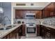 Well-equipped kitchen boasts stainless steel appliances, granite countertops, and mosaic tile backsplash at 5694 40Th N Ter # 423, Kenneth City, FL 33709