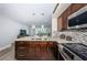 Kitchen boasts stainless steel appliances, granite countertops, and dark wood cabinets with an island at 5694 40Th N Ter # 423, Kenneth City, FL 33709