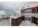 Well-lit kitchen with stainless steel appliances, granite countertops, and breakfast bar seating at 5694 40Th N Ter # 423, Kenneth City, FL 33709