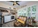 Bright laundry room with new appliances and a comfortable wicker seating area with shuttered windows at 5694 40Th N Ter # 423, Kenneth City, FL 33709