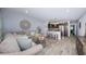 Bright living room featuring hardwood floors, modern decor, and an open layout leading to the kitchen at 5694 40Th N Ter # 423, Kenneth City, FL 33709