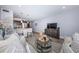 Open concept living room with a modern decor, seamless flooring, and an inviting atmosphere at 5694 40Th N Ter # 423, Kenneth City, FL 33709
