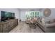 Comfortable living room boasts stylish furniture, hardwood floors, and abundant natural light at 5694 40Th N Ter # 423, Kenneth City, FL 33709
