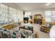 Cozy lounge area with comfortable seating, a TV, and bookshelves for relaxation and entertainment at 5694 40Th N Ter # 423, Kenneth City, FL 33709