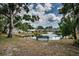 Scenic view of the community pond with a fountain, surrounded by trees and greenery at 5694 40Th N Ter # 423, Kenneth City, FL 33709