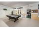 Community recreation room with a covered pool table, perfect for social gatherings and leisure at 5694 40Th N Ter # 423, Kenneth City, FL 33709