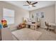 Well-lit bedroom with neutral walls, a cozy rug, and a desk area, creating a comfortable and functional space at 5724 Shell Ridge Dr, Lithia, FL 33547