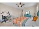 Bright bedroom featuring ample natural light, a ceiling fan, and neutral tones for a relaxing atmosphere at 5724 Shell Ridge Dr, Lithia, FL 33547