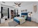 Cozy bedroom featuring a ceiling fan, comfortable bed, and a window overlooking the backyard at 5724 Shell Ridge Dr, Lithia, FL 33547