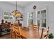 Bright dining room with plantation shutters, modern lighting and seating for six at 5724 Shell Ridge Dr, Lithia, FL 33547