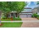 Beautiful two-story home featuring a brick driveway, a spacious two-car garage, and a lush landscaped yard at 5724 Shell Ridge Dr, Lithia, FL 33547