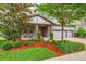 Inviting home exterior with landscaped front yard and a brick driveway leading to a convenient two-car garage at 5724 Shell Ridge Dr, Lithia, FL 33547