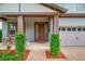 Welcoming front porch featuring lush landscaping and a cozy seating area, perfect for relaxing outdoors at 5724 Shell Ridge Dr, Lithia, FL 33547
