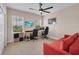 A spacious home office featuring dual workstations, a comfortable seating area, and ample natural light at 5724 Shell Ridge Dr, Lithia, FL 33547