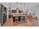 Bright kitchen boasting an expansive island with seating, stainless steel appliances, and dining area with natural light at 5724 Shell Ridge Dr, Lithia, FL 33547