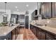 Well-equipped kitchen with a large island, stainless steel appliances, dark cabinetry, and modern backsplash at 5724 Shell Ridge Dr, Lithia, FL 33547