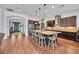 Spacious kitchen featuring a large island with seating, stainless steel appliances, and dark cabinetry at 5724 Shell Ridge Dr, Lithia, FL 33547