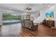 Bright living room with pool view and hardwood floors and comfortable seating at 5724 Shell Ridge Dr, Lithia, FL 33547