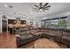 Comfortable living room with gray sofa and open floor plan to kitchen and dining area at 5724 Shell Ridge Dr, Lithia, FL 33547