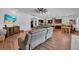 Open-concept living room with hardwood floors and view of kitchen and dining area at 5724 Shell Ridge Dr, Lithia, FL 33547
