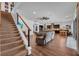 Bright, open living space flowing into the kitchen and dining area, featuring modern staircase and hardwood floors at 5724 Shell Ridge Dr, Lithia, FL 33547