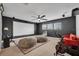 Spacious movie room with a large screen, comfortable seating, and an exercise bike for entertainment and fitness at 5724 Shell Ridge Dr, Lithia, FL 33547