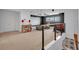 Upstairs bonus room featuring home movie setup, drop lighting, exercise equipment and additional seating at 5724 Shell Ridge Dr, Lithia, FL 33547