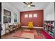 Bright playroom with colorful rug, a wooden table with chairs, and ample natural light at 5724 Shell Ridge Dr, Lithia, FL 33547
