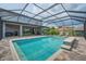 Inviting screened pool area with a summer kitchen, seating, and a large patio at 5724 Shell Ridge Dr, Lithia, FL 33547