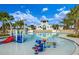 Beautiful community pool with a splash pad and towering palms at 5724 Shell Ridge Dr, Lithia, FL 33547